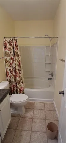 a bathroom with a bathtub and shower