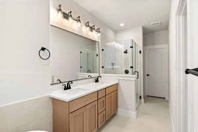 a bathroom with a sink double vanity and a mirror