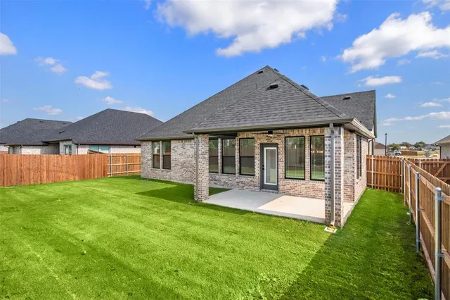 a view of a house with a yard and sitting area
