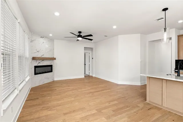 a view of a kitchen with a sink and a refrigerator