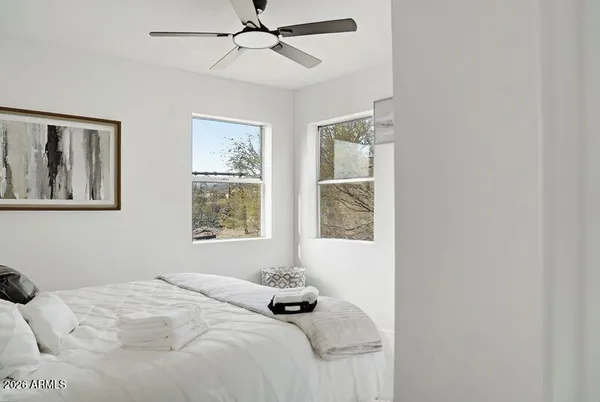 a bedroom with a bed and a window