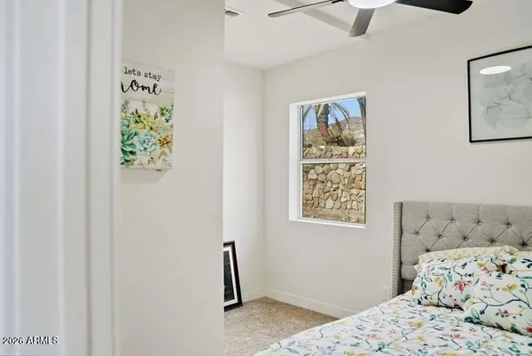 a bedroom with a bed and a window