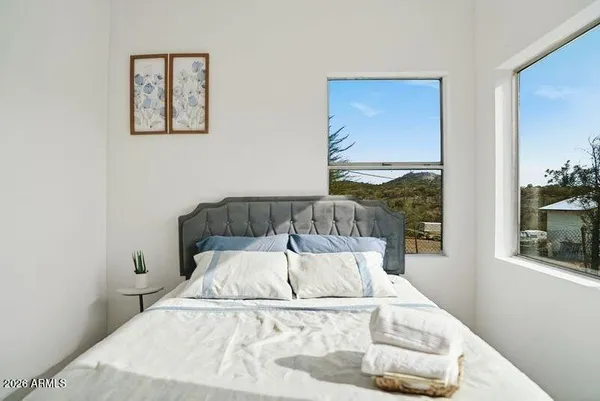 a bed sitting in a bedroom next to a window