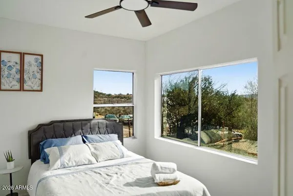 a bedroom with furniture and a large window