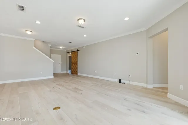 a view of kitchen with a sink wooden cabinets and stainless steel appliances