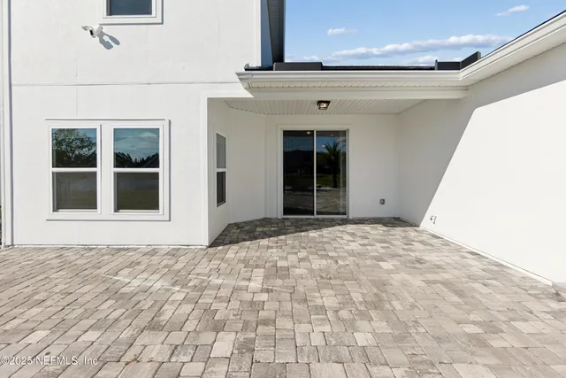 a view of a patio with table and chairs with wooden floor and fence