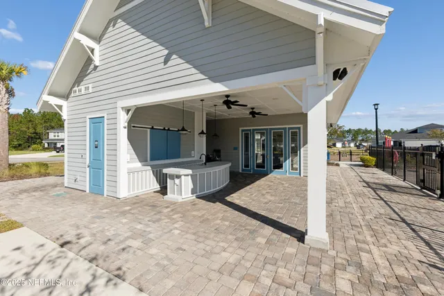 a view of a house with backyard and sitting area