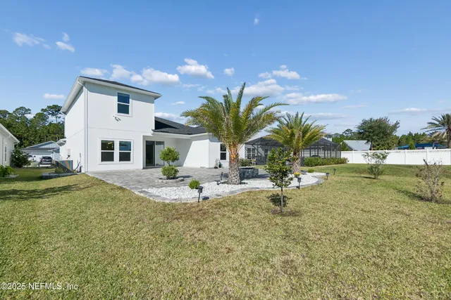 a front view of house with yard and trees