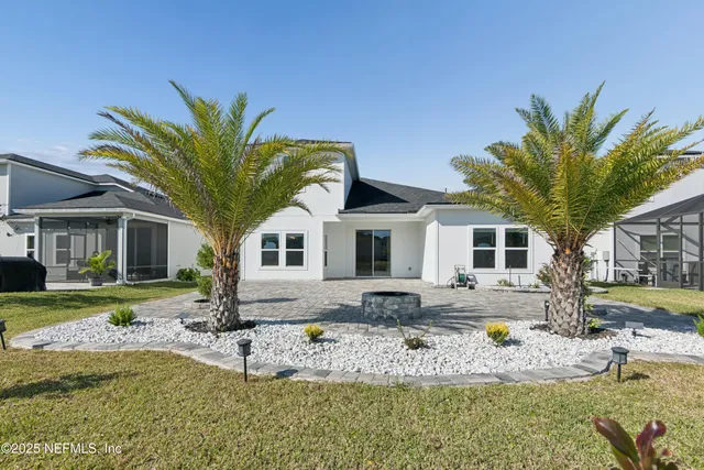 a view of a house with swimming pool and a yard