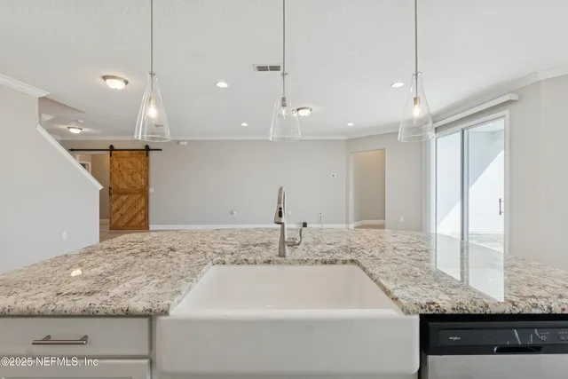 a kitchen with stainless steel appliances kitchen island a sink stove and cabinets