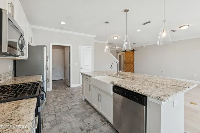 a view of a big room with wooden floor and windows