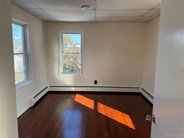 a view of a room with wooden floor and window
