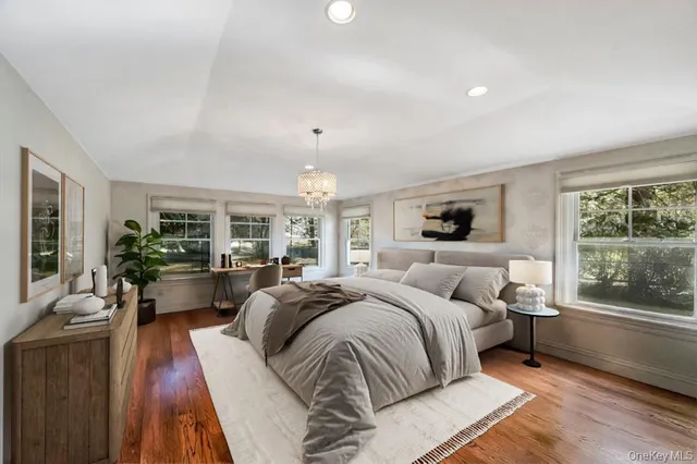 a bedroom with a large bed and windows