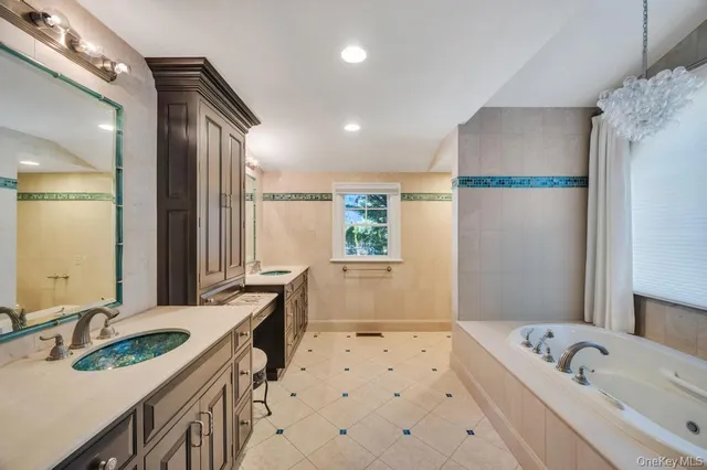 a bathroom with a bathtub a sink a vanity and a shower