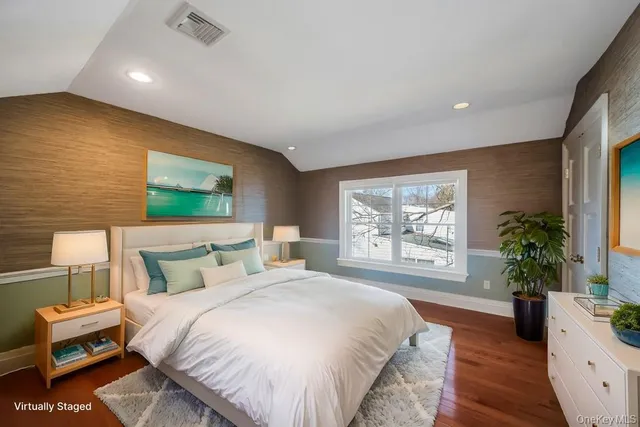 a bedroom with a large bed and a large window