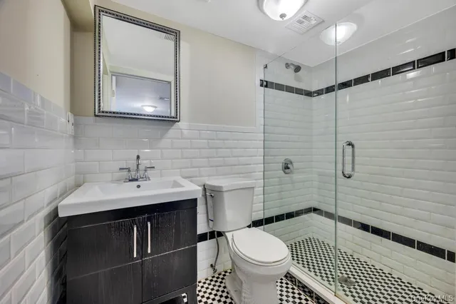 a bathroom with a sink toilet a mirror and shower