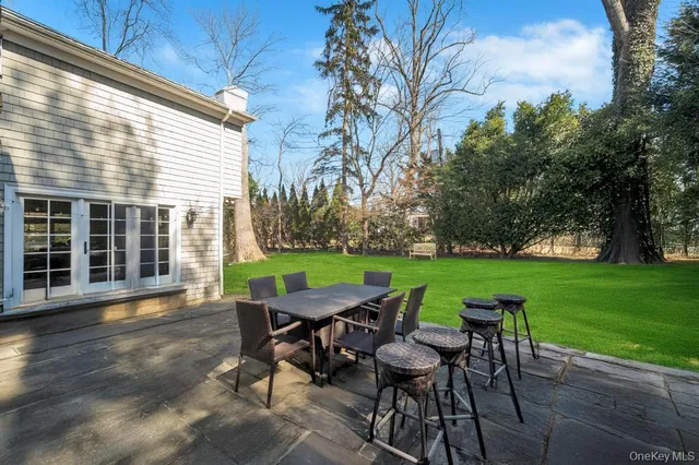 a view of a house with backyard sitting area and garden