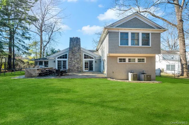 a front view of house with yard and green space