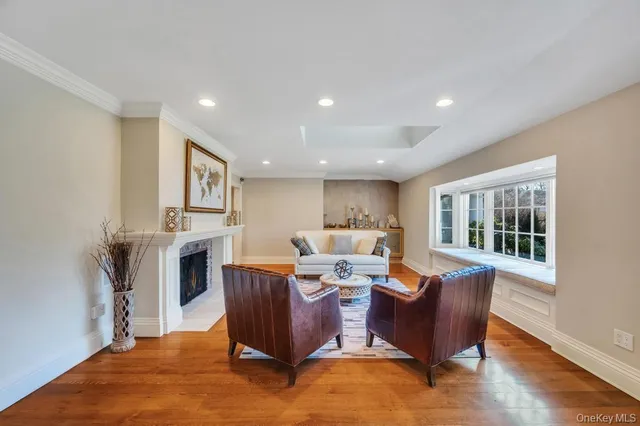 a living room with fireplace furniture and a window