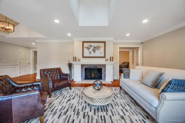 a living room with furniture a fireplace and a large mirror