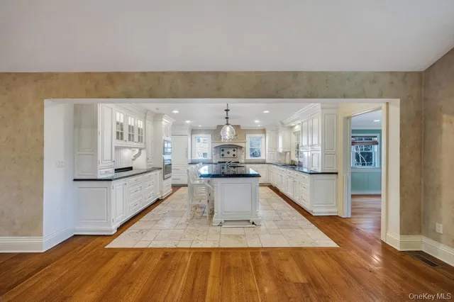 a large kitchen with kitchen island sink and a stove