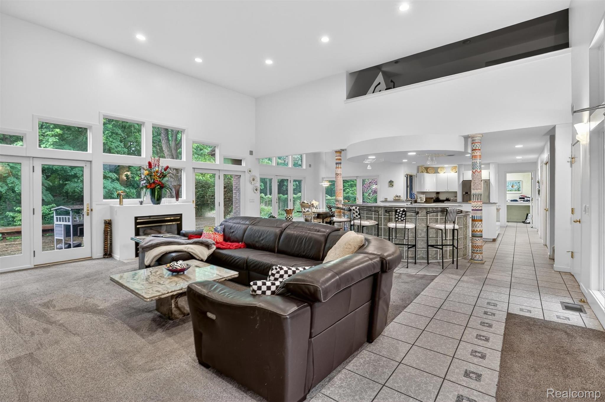 2197 South State Road Davison, MI 48423 - Photo 13 of 72 Spacious living area featuring a fireplace, a high ceiling, recessed lighting, and expansive windows