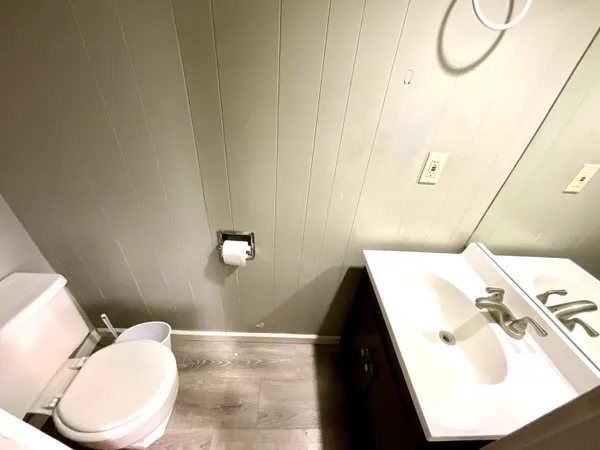 a bathroom with a sink and mirror with toilet