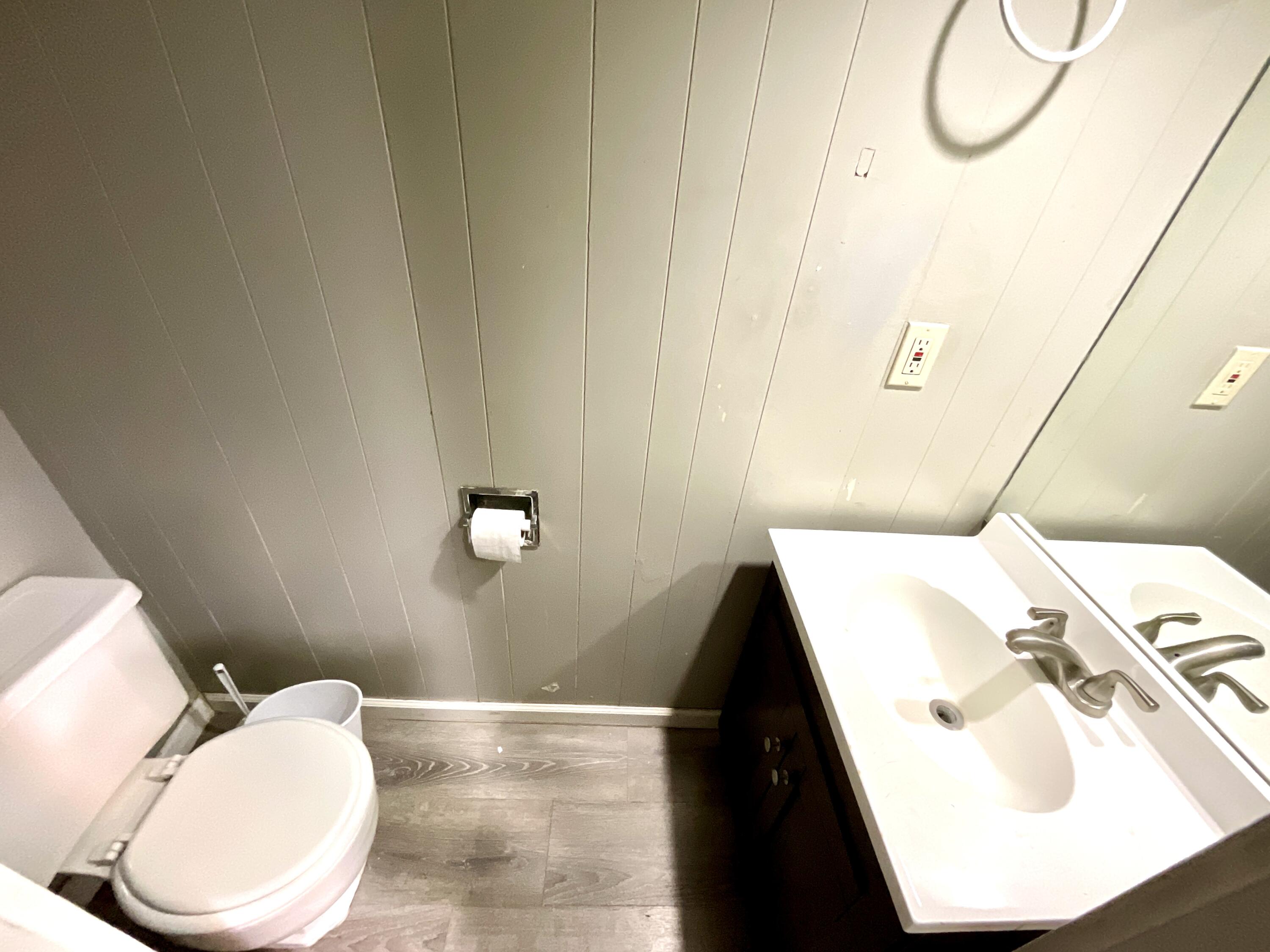 2004 30th Street Lubbock, TX 79411 - Photo 4 of 9 a bathroom with a sink and mirror with toilet