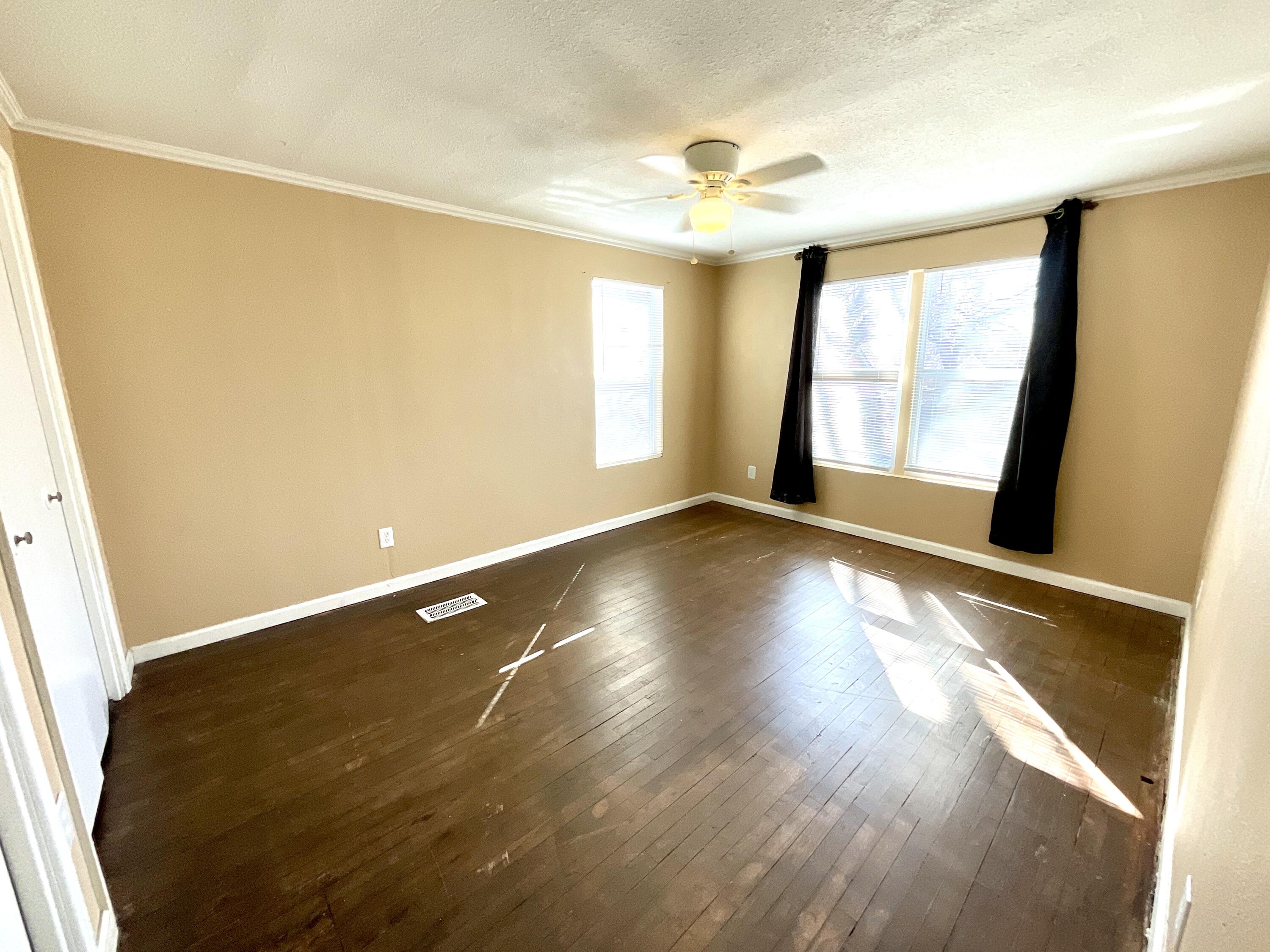 2004 30th Street Lubbock, TX 79411 - Photo 8 of 9 a view of an empty room with wooden floor and a window