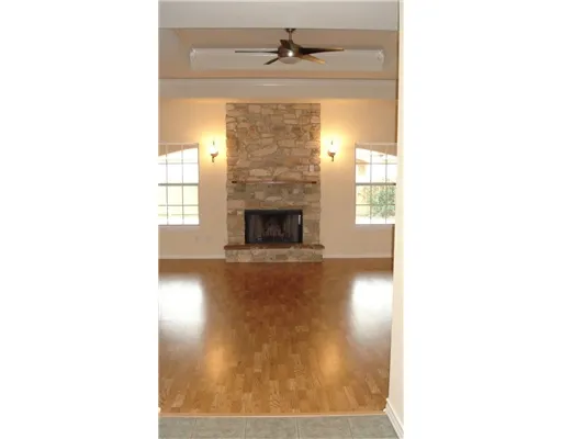 a living room with a fireplace and a table