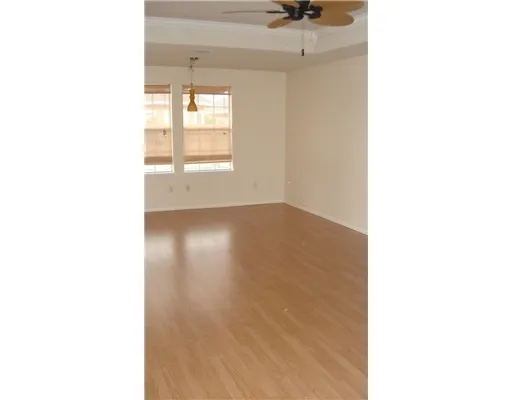 a view of a room with a window and ceiling fan