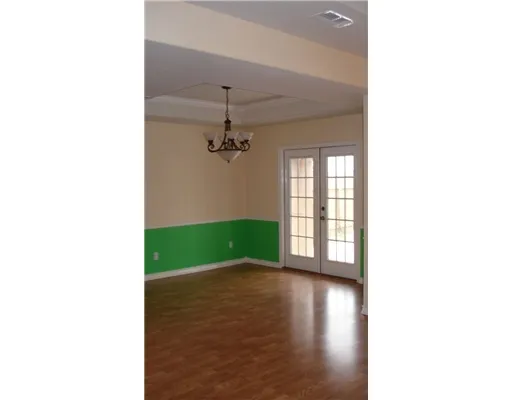 a view of a room with window and hardwood floor