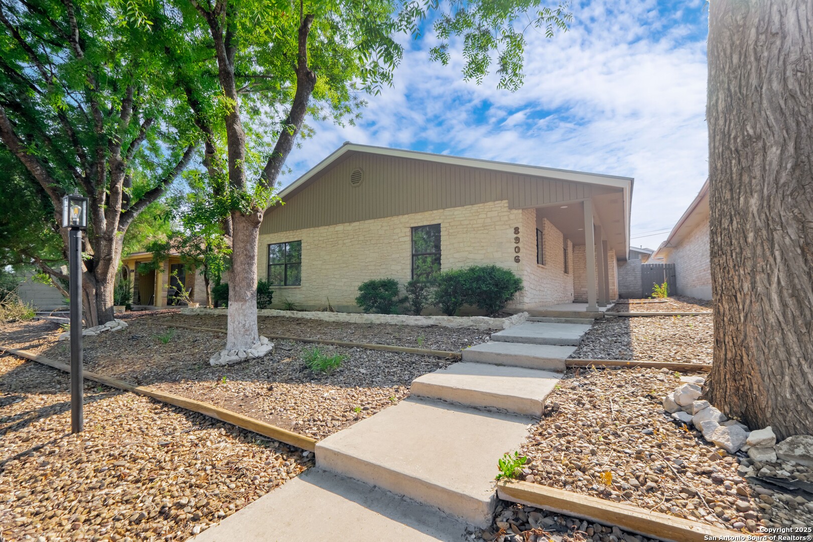 8906 Willmon Way Windcrest, TX 78239 - Photo 1 of 34 a front view of a house with garden