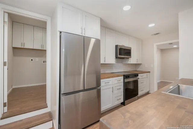 a kitchen with a refrigerator stove and sink