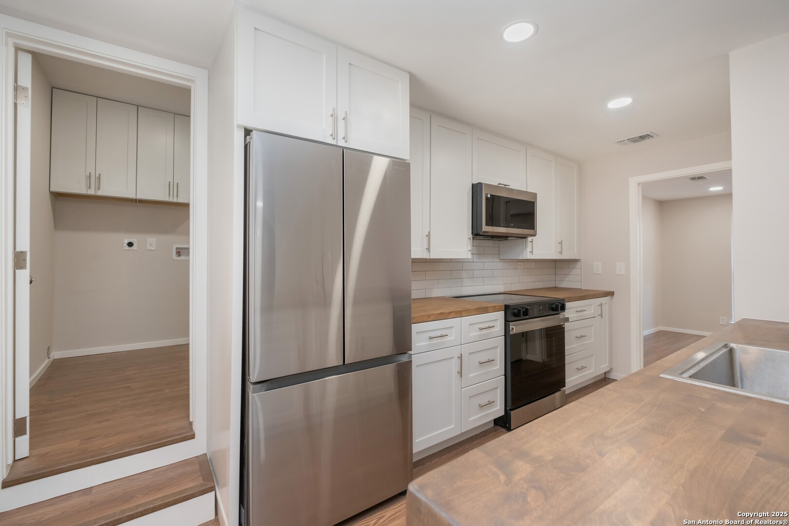 8906 Willmon Way Windcrest, TX 78239 - Photo 12 of 34 a kitchen with a refrigerator stove and sink