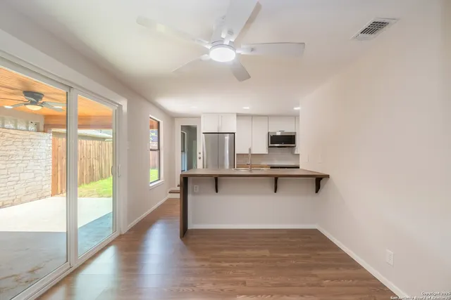 a view of kitchen with sink and microwave