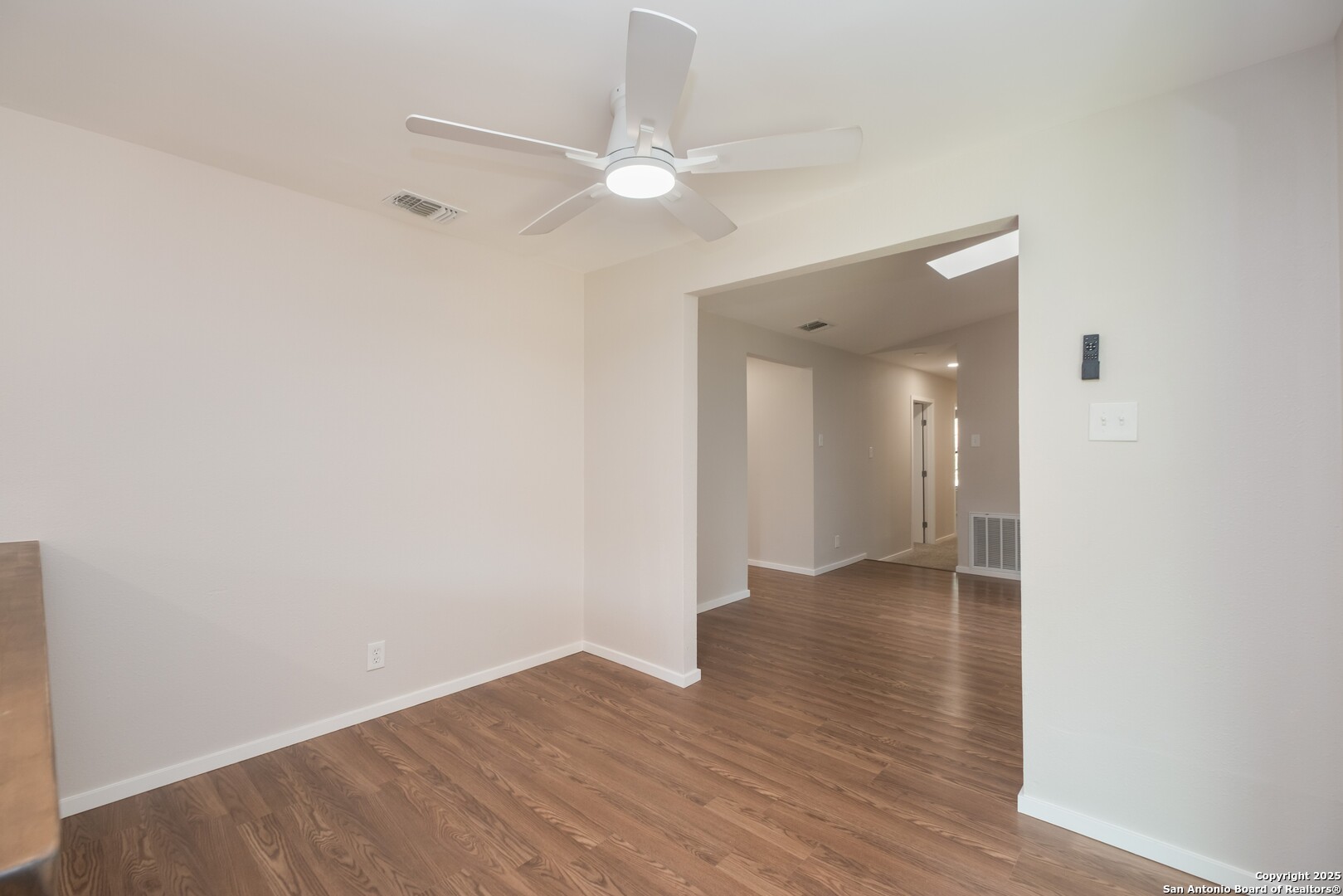8906 Willmon Way Windcrest, TX 78239 - Photo 14 of 34 a view of an empty room with wooden floor