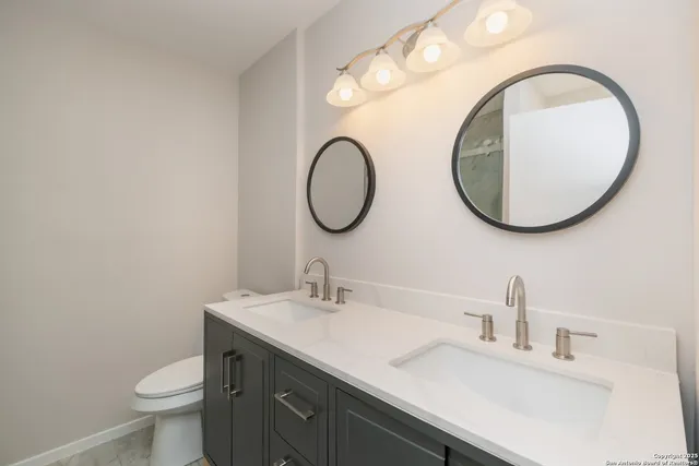 a bathroom with a toilet sink and mirror