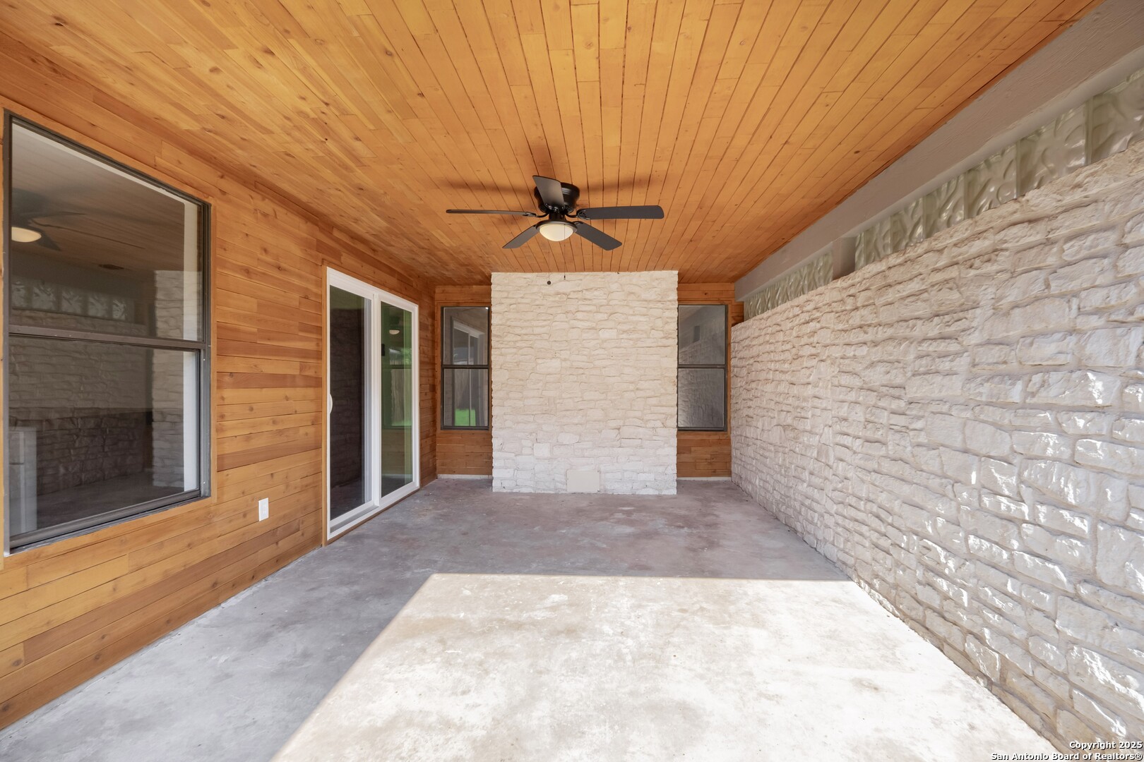 8906 Willmon Way Windcrest, TX 78239 - Photo 29 of 34 a view of a hallway with a ceiling fan