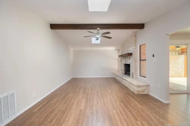 wooden floor in an empty room with a window