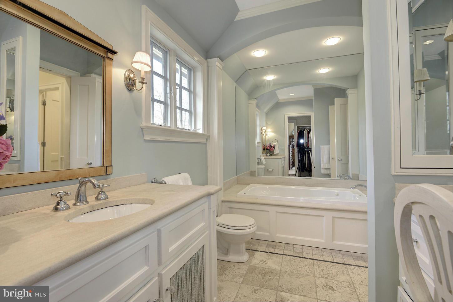 8106 Merrick Road Bethesda, MD 20817 - Photo 15 of 27 a bathroom with a granite countertop sink mirror and toilet