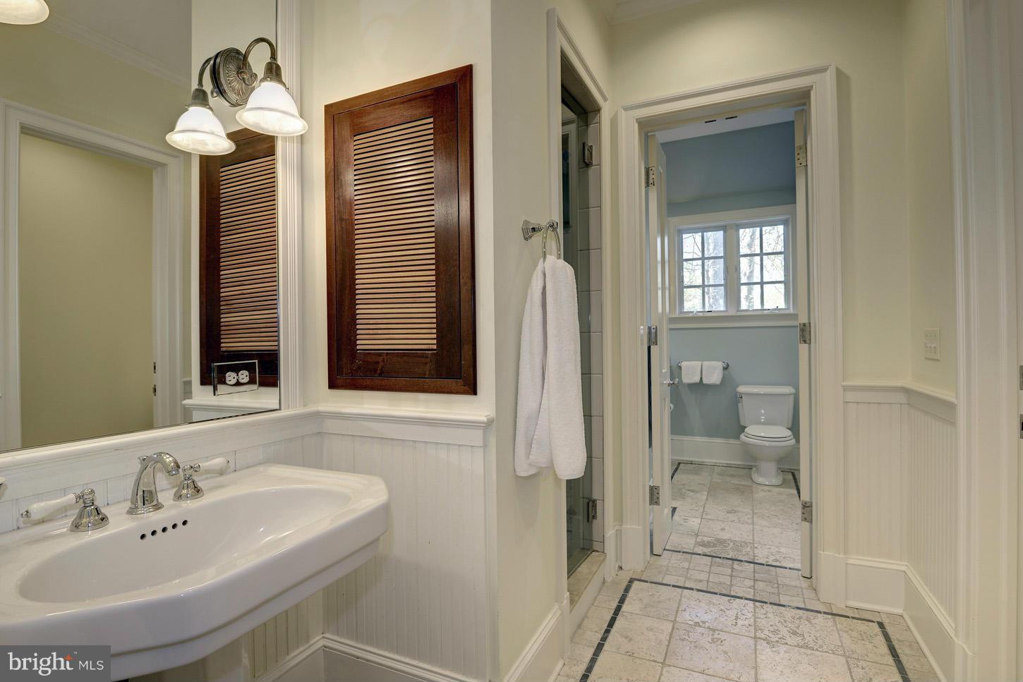 8106 Merrick Road Bethesda, MD 20817 - Photo 16 of 27 a bathroom with a sink and a mirror