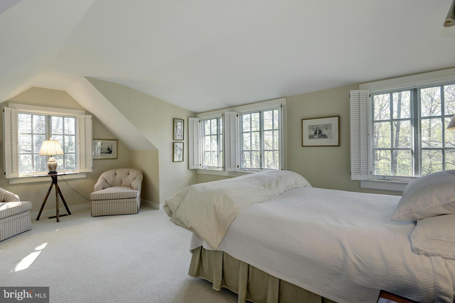 8106 Merrick Road Bethesda, MD 20817 - Photo 21 of 27 a bedroom with a balcony a bed and a couch