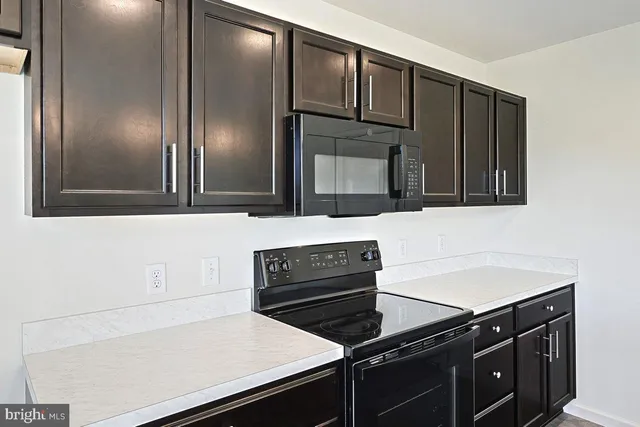 a kitchen with a sink and a refrigerator
