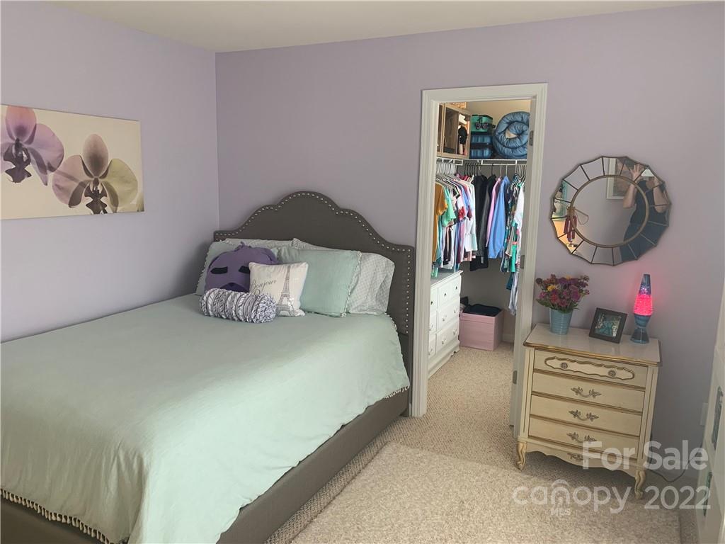 6518 Del Rio Road Charlotte, NC 28277 - Photo 12 of 19 a spacious bedroom with a bed a dresser and book shelf
