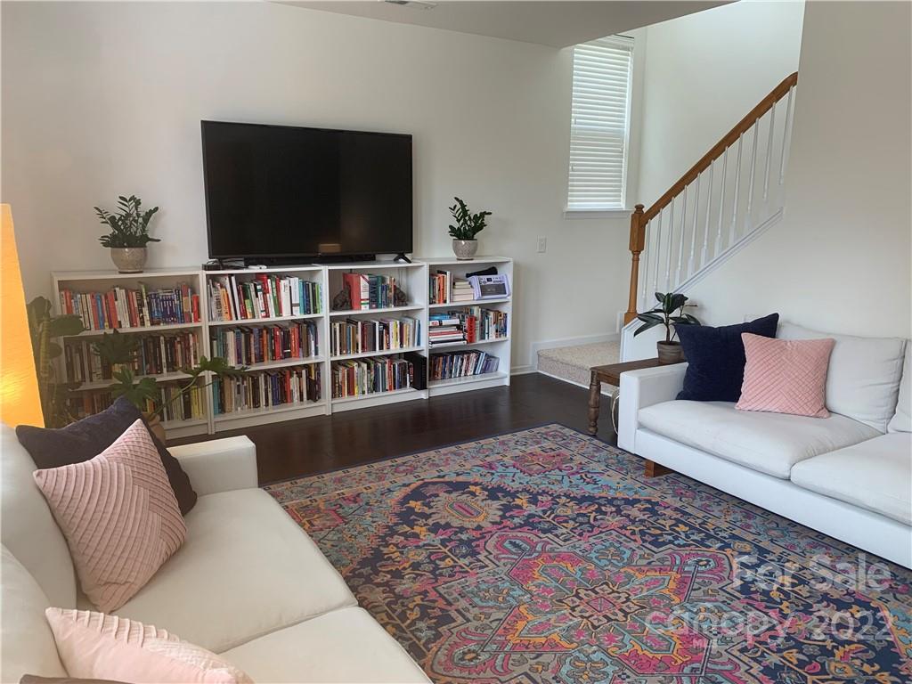 6518 Del Rio Road Charlotte, NC 28277 - Photo 5 of 19 a living room with a flat screen tv and a book shelf