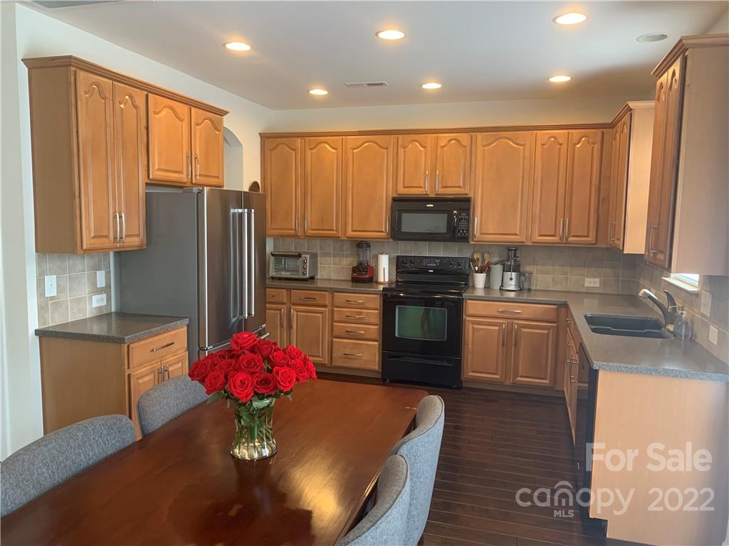 6518 Del Rio Road Charlotte, NC 28277 - Photo 7 of 19 a kitchen with stainless steel appliances granite countertop a refrigerator sink and cabinets