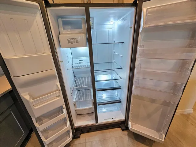 an open kitchen with white cabinets and stainless steel appliances