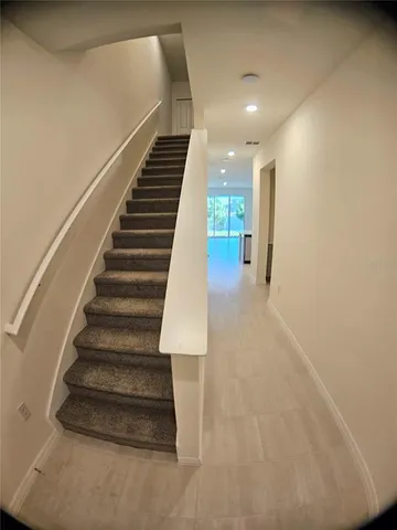 a view of a hallway to rooms