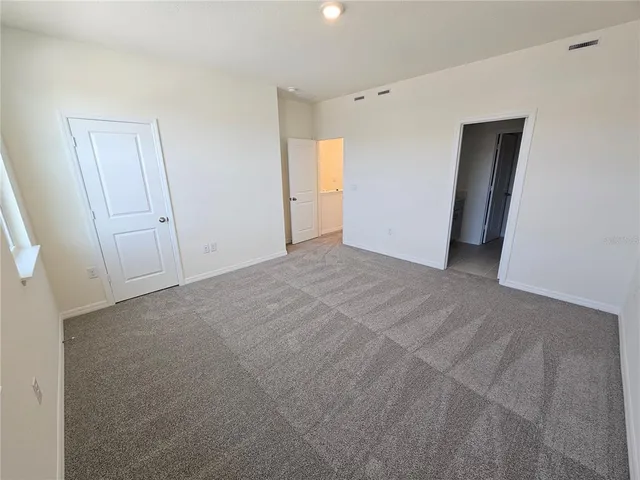 a bathroom with a sink and mirror with bathtub